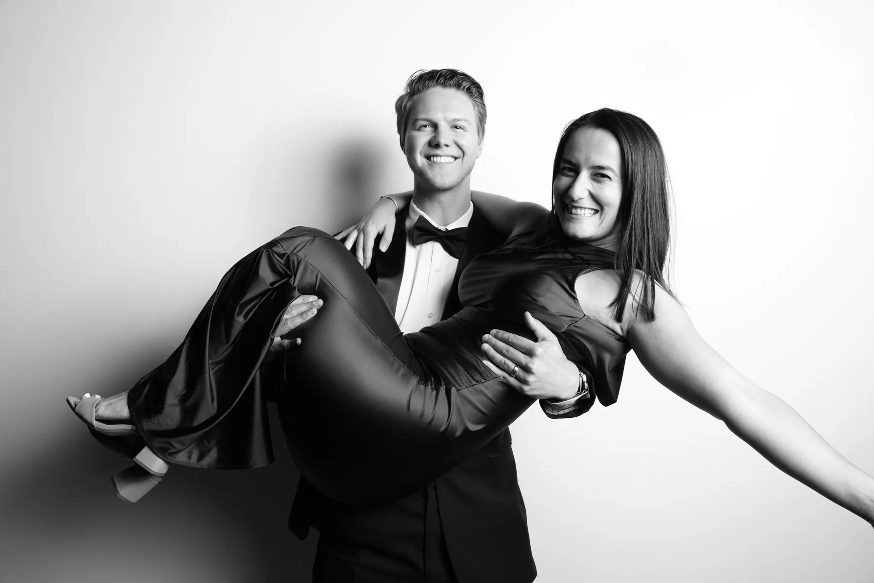 Two wedding guests sharing a playful directed portrait