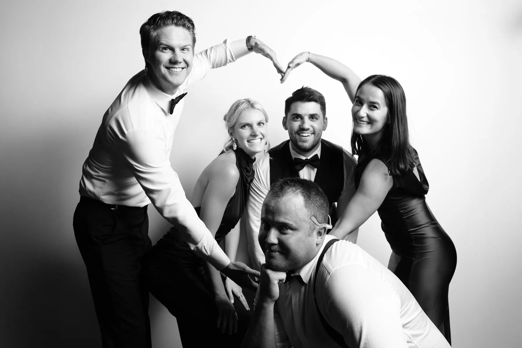 A group of wedding guests gathering for a playful directed portrait