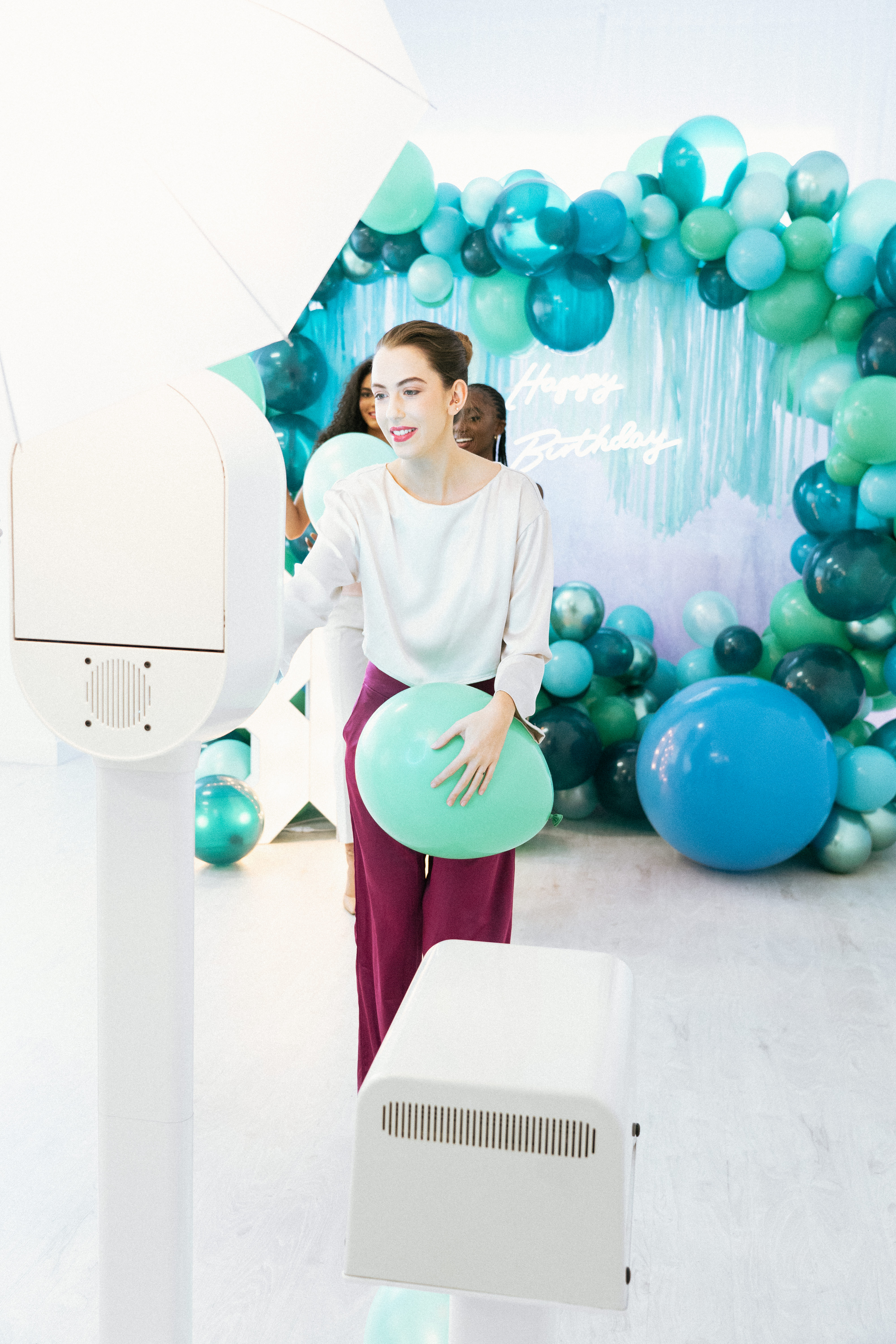Guests with balloons at the booth